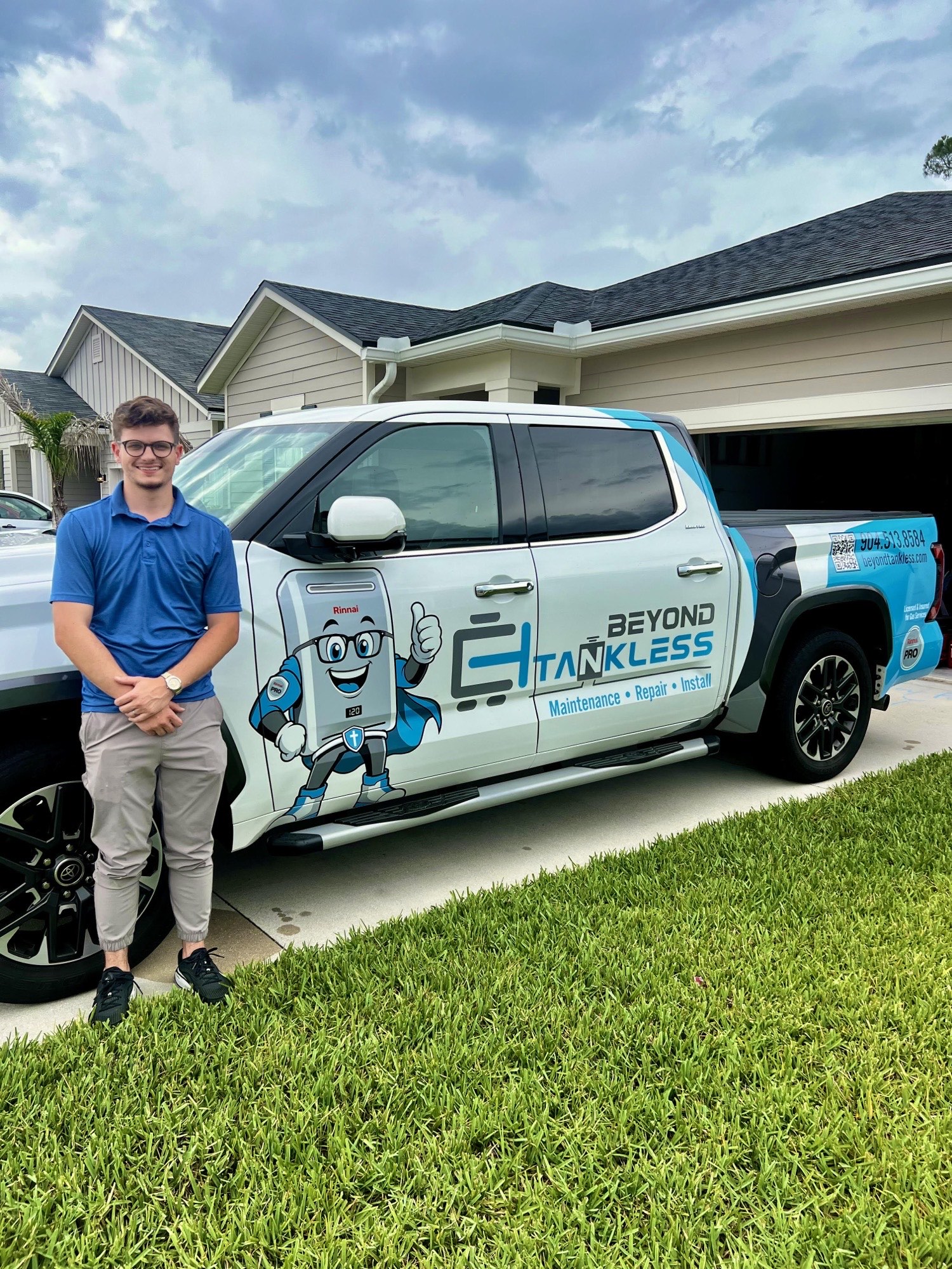 Beyond Tankless technician with the company truck in front of a Nassau County, Florida home