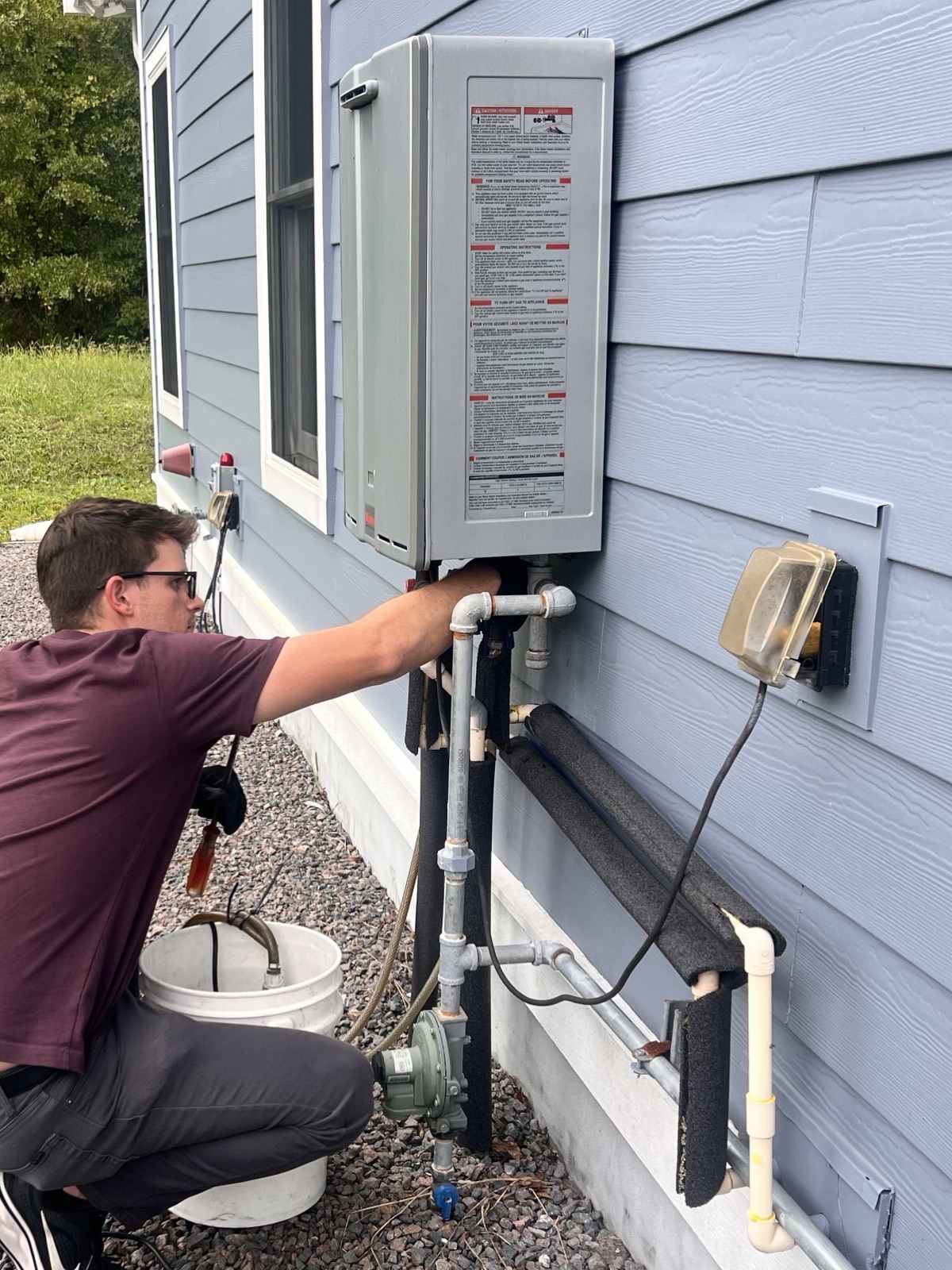 Beyond Tankless technician servicing a Rinnai tankless water heater in Nassau County, Florida